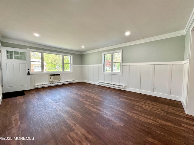 unfurnished room with crown molding, a baseboard heating unit, and a wealth of natural light