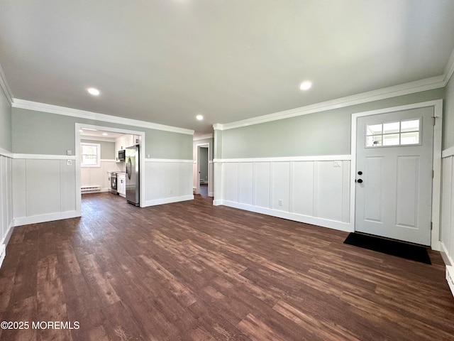 entryway with wainscoting, dark wood finished floors, and ornamental molding