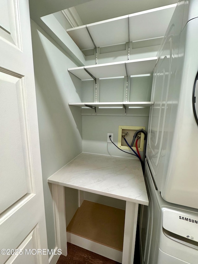 washroom featuring laundry area and stacked washer / drying machine