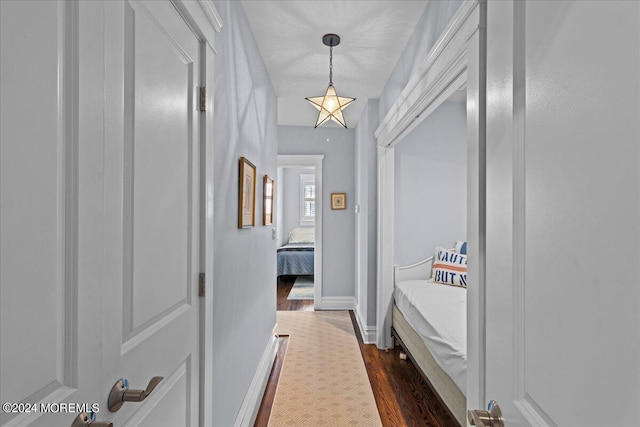 corridor with baseboards and dark wood finished floors