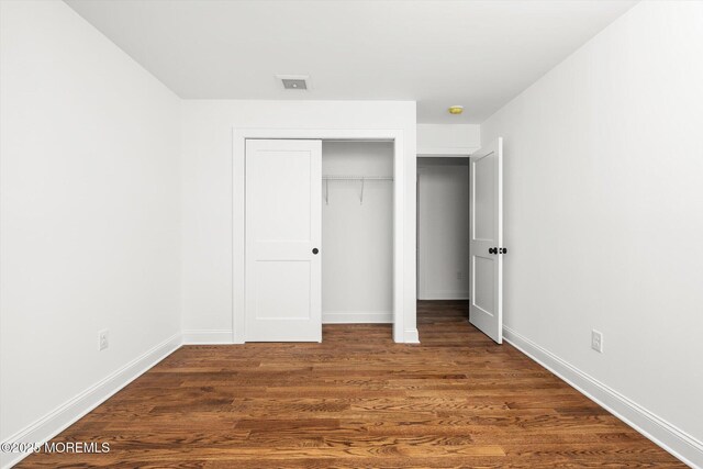 440 Ellisdale Rd, Chesterfield, NJ 08515 - unfurnished bedroom with baseboards, dark wood finished floors, and a closet