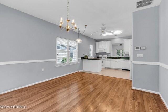 21 Edgeworth Cir, Manchester, NJ 08759 - kitchen with white cabinets, light wood finished floors, white appliances, ceiling fan with notable chandelier, and visible vents