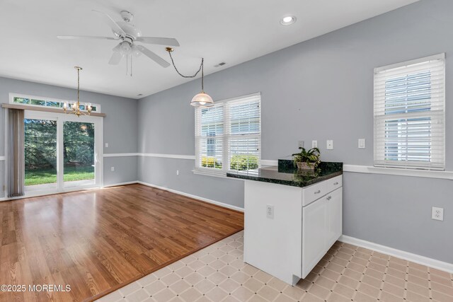 21 Edgeworth Cir, Manchester, NJ 08759 - kitchen featuring white cabinetry, baseboards, ceiling fan with notable chandelier, and a peninsula