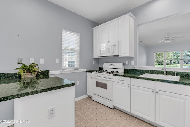 21 Edgeworth Cir, Manchester, NJ 08759 - kitchen featuring white cabinets, ceiling fan, a sink, white appliances, and baseboards