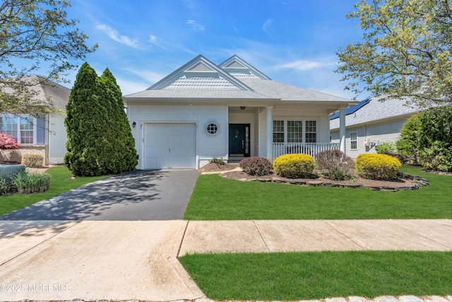 21 Edgeworth Cir, Manchester, NJ 08759 - ranch-style house featuring covered porch, driveway, a front lawn, and a garage