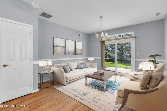 21 Edgeworth Cir, Manchester, NJ 08759 - living room featuring visible vents, light wood-style flooring, baseboards, and a notable chandelier