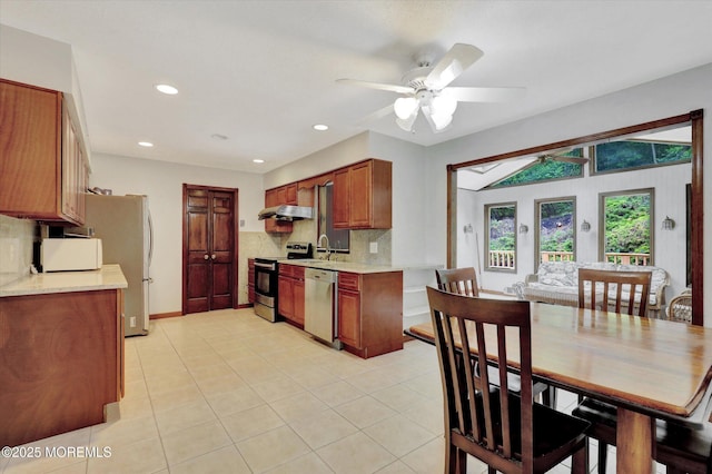9 Berkshire Ct, Holmdel, NJ 07733 - kitchen with stainless steel appliances, light countertops, decorative backsplash, ceiling fan, and extractor fan