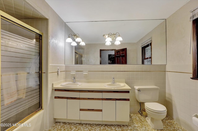 9 Berkshire Ct, Holmdel, NJ 07733 - bathroom with tile walls, toilet, double vanity, combined bath / shower with glass door, and backsplash