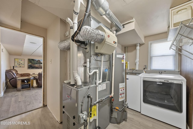utility room with gas water heater and independent washer and dryer