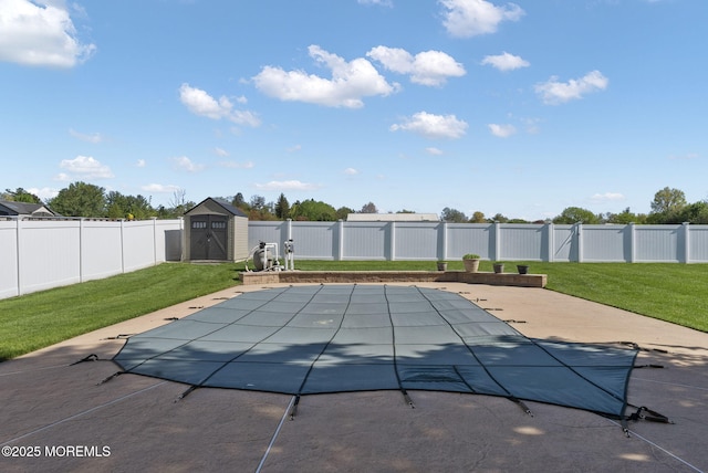 view of pool featuring a fenced backyard, a patio, an outbuilding, and a shed