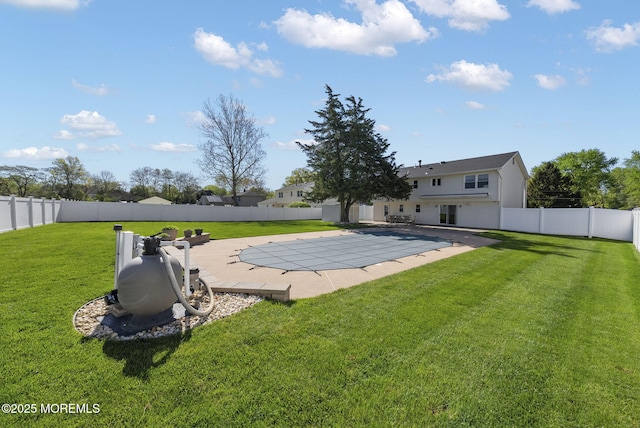 view of pool featuring a yard, a fenced backyard, and a patio area