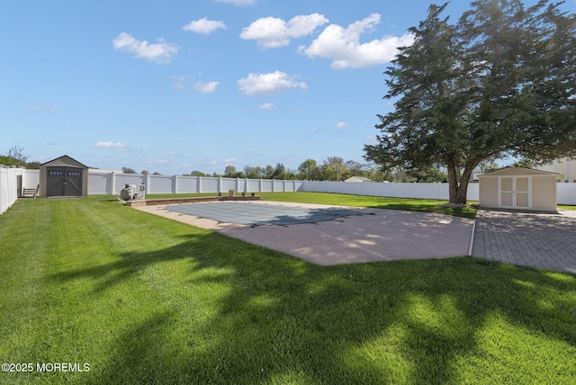 exterior space featuring an outbuilding, a shed, a fenced backyard, and a patio area