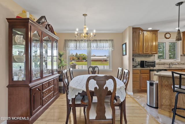 dining area featuring a toaster, a notable chandelier, recessed lighting, and a wealth of natural light