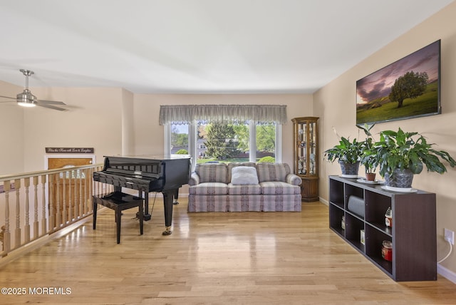 living room featuring ceiling fan and wood finished floors