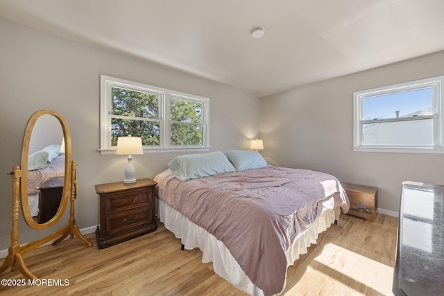 bedroom with baseboards and light wood-style flooring