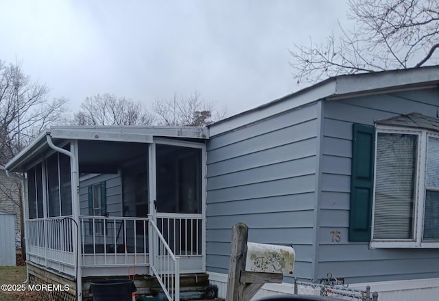 view of property exterior featuring a sunroom