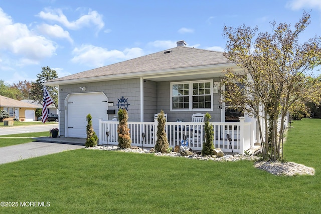ranch-style home with a garage, asphalt driveway, a front yard, covered porch, and a shingled roof