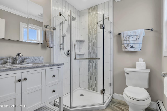 full bathroom with toilet, baseboard heating, a stall shower, crown molding, and baseboards