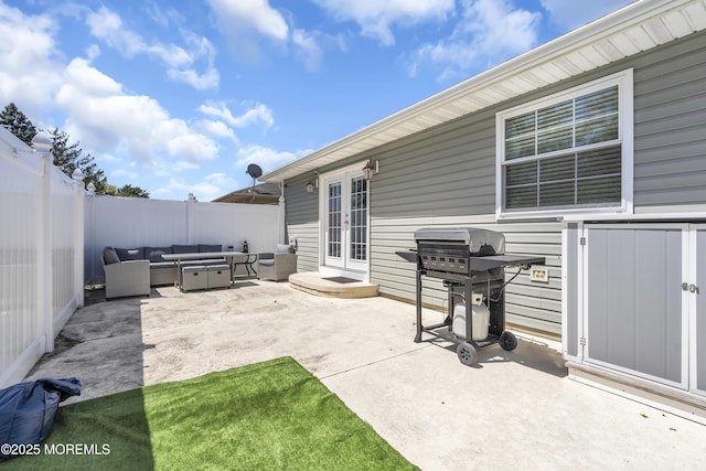 view of patio with an outdoor living space, a fenced backyard, and area for grilling