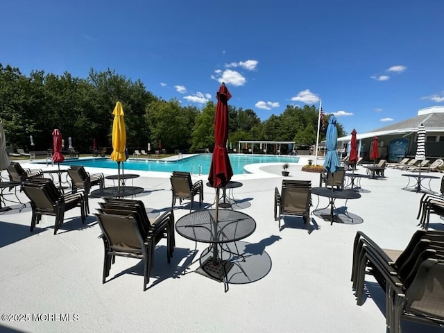 community pool with a patio area