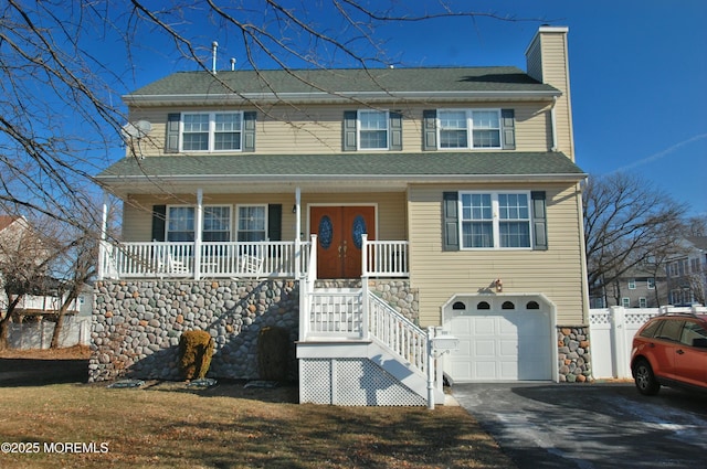 711 Edmunds Ave, Union Beach, NJ 07735 - view of front of home with an attached garage, stairway, a chimney, covered porch, and driveway