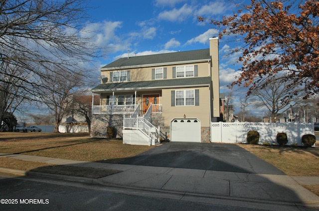 711 Edmunds Ave, Union Beach, NJ 07735 - view of front of home featuring a garage, aphalt driveway, covered porch, a chimney, and stairway