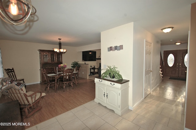 711 Edmunds Ave, Union Beach, NJ 07735 - interior space with light tile patterned flooring, baseboards, and a notable chandelier