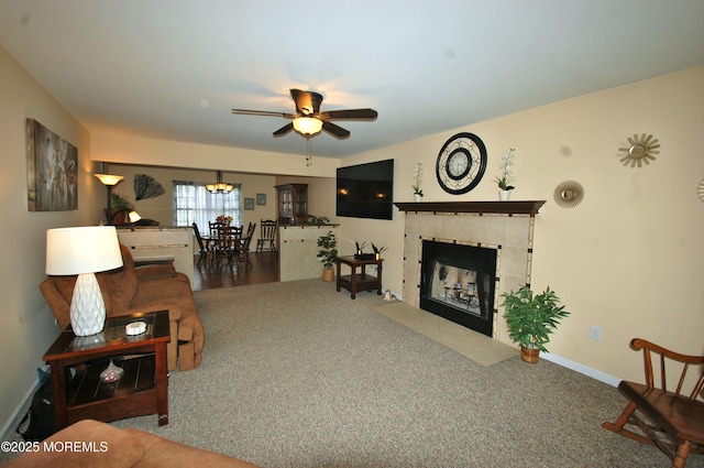 711 Edmunds Ave, Union Beach, NJ 07735 - living room with baseboards, carpet flooring, ceiling fan with notable chandelier, and a tile fireplace