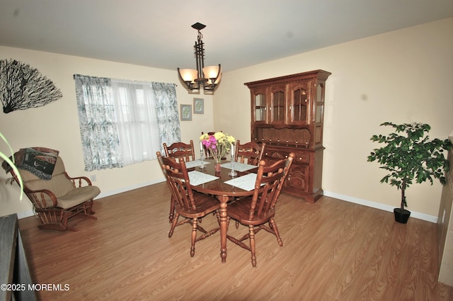 711 Edmunds Ave, Union Beach, NJ 07735 - dining area featuring light wood-style floors, baseboards, and a notable chandelier