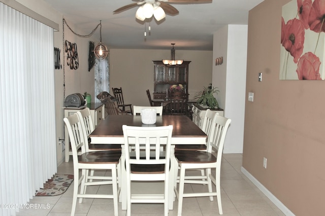 711 Edmunds Ave, Union Beach, NJ 07735 - dining area featuring baseboards, light tile patterned floors, and ceiling fan with notable chandelier