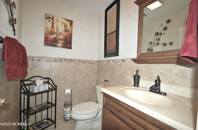 711 Edmunds Ave, Union Beach, NJ 07735 - bathroom featuring tile walls, a wainscoted wall, vanity, and toilet