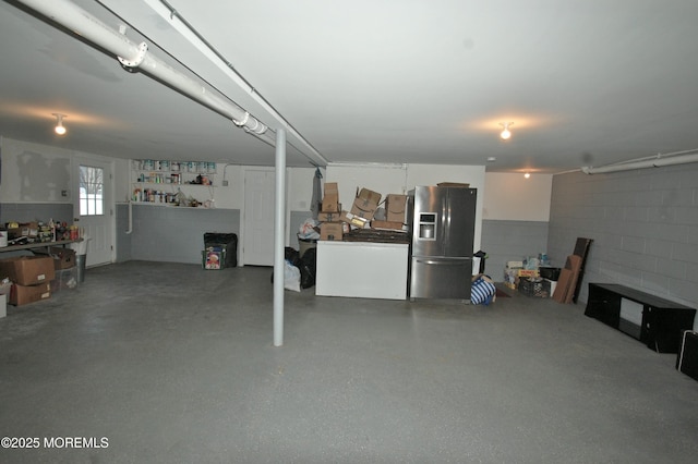 711 Edmunds Ave, Union Beach, NJ 07735 - garage featuring concrete block wall and stainless steel fridge with ice dispenser