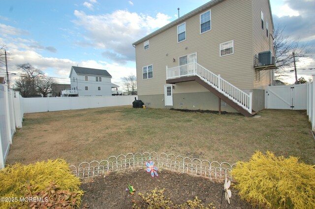 711 Edmunds Ave, Union Beach, NJ 07735 - rear view of property featuring a fenced backyard, a gate, a yard, and cooling unit