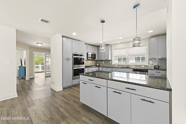 305 W 18th St, Ship Bottom, NJ 08008 - kitchen featuring a sink, appliances with stainless steel finishes, backsplash, dark wood-style flooring, and dark stone countertops
