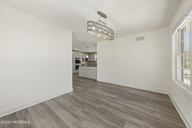 305 W 18th St, Ship Bottom, NJ 08008 - unfurnished living room with dark wood-style floors, baseboards, recessed lighting, and a chandelier