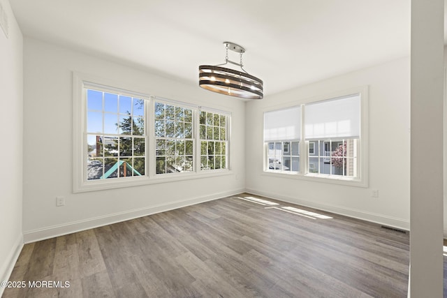 305 W 18th St, Ship Bottom, NJ 08008 - unfurnished dining area featuring a chandelier, wood finished floors, and baseboards