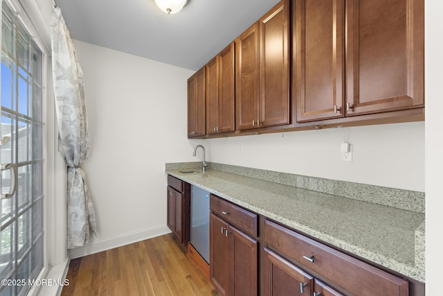 305 W 18th St, Ship Bottom, NJ 08008 - kitchen with a sink, light wood-style floors, light stone counters, baseboards, and brown cabinets