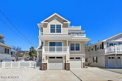 305 W 18th St, Ship Bottom, NJ 08008 - coastal inspired home featuring a garage, concrete driveway, and a balcony
