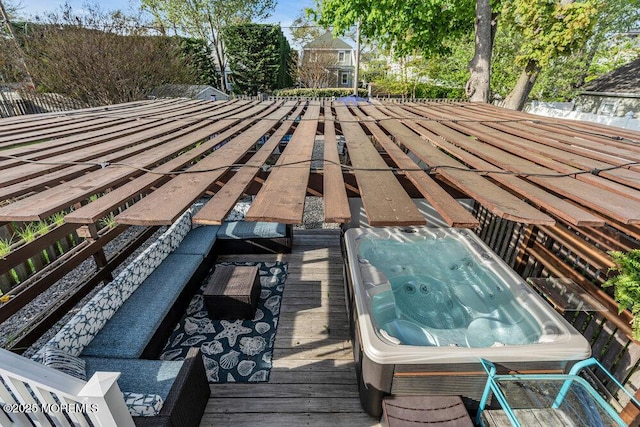 deck featuring hot tub deck surround
