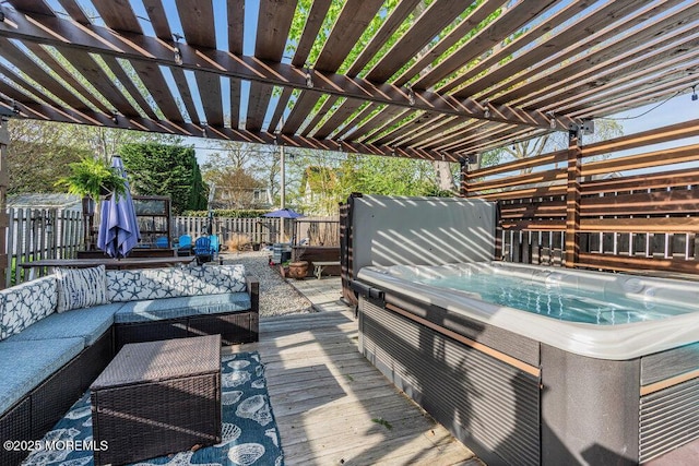 wooden terrace with a fenced backyard, a pergola, a hot tub, and outdoor lounge area