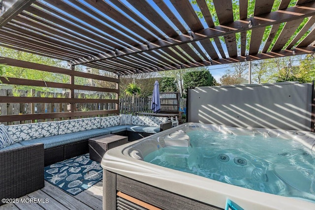 wooden terrace with an outdoor living space, a hot tub, and fence