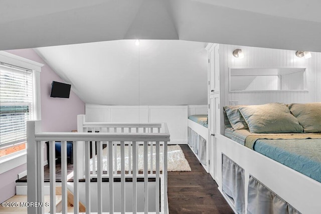 bedroom with vaulted ceiling and dark wood-type flooring