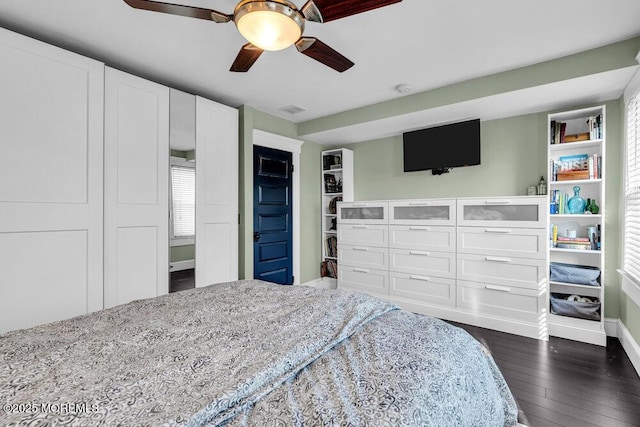 bedroom featuring baseboards, visible vents, multiple windows, and dark wood finished floors