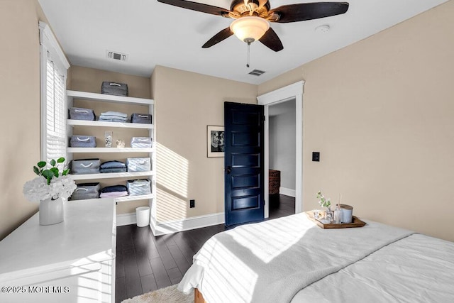 bedroom featuring baseboards, a ceiling fan, dark wood-style flooring, and visible vents