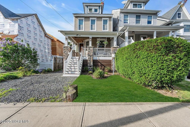 traditional style home with stairs, a front lawn, and covered porch