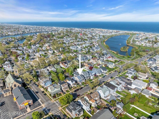 drone / aerial view featuring a water view and a residential view