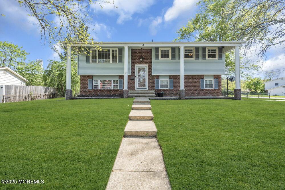 4 Minnesota Dr, Jackson, NJ 08527 - split foyer home with fence, a front lawn, and brick siding