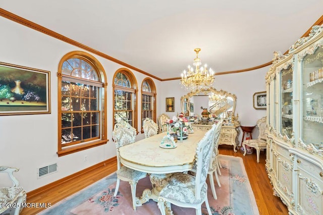 8 Tiberon Dr, Holmdel, NJ 07733 - dining room with crown molding, a notable chandelier, visible vents, and wood finished floors