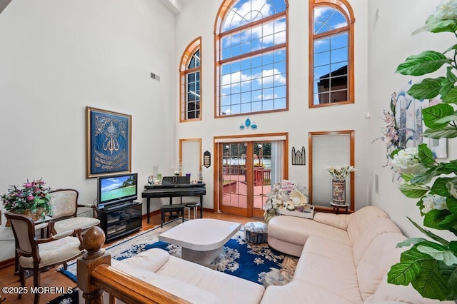 8 Tiberon Dr, Holmdel, NJ 07733 - living room with visible vents, wood finished floors, and a towering ceiling