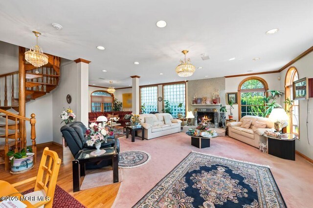 8 Tiberon Dr, Holmdel, NJ 07733 - carpeted living room featuring a notable chandelier, recessed lighting, ornamental molding, a healthy amount of sunlight, and stairway